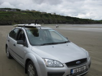 Rossnowlagh beach, car, and B&B in background